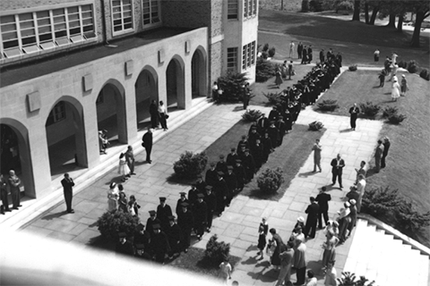 Members of Fisher's Pioneer Class celebrate Commencement in Spring 1955 in front of Kearney Hall.