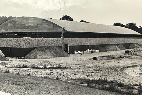 Black and white photos of construction progress on the athletic center.