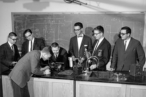 Black and white photo of students at Fisher in a science lab.