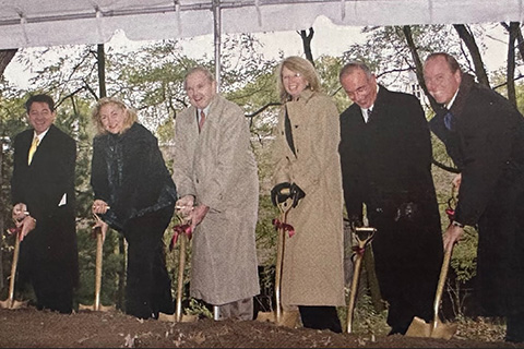 A group holding shovels at the groundbreaking for the School of Education