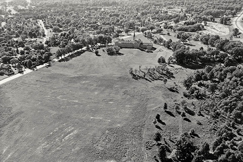 Aerial view of Kearney Hall and undeveloped campus field.