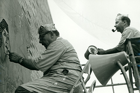 Two painters working on the mural on the side of Kearney Hall, circa 1966.