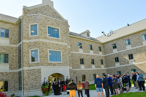 A group at the ribbon cutting dedication ceremony of Upper Quad residence hall