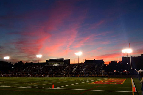 Landscape view of sunset over the football field at Fisher.