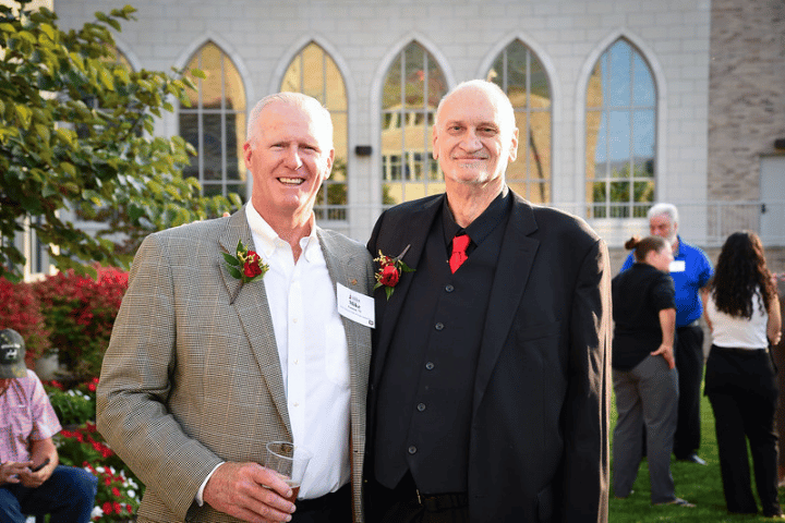 Two Athletic Hall of Fame inductees stand together for a photo