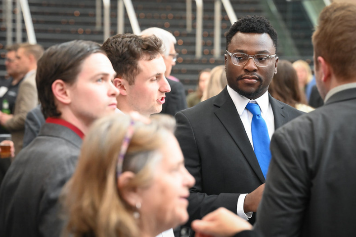 Individuals in professional attired gathered together