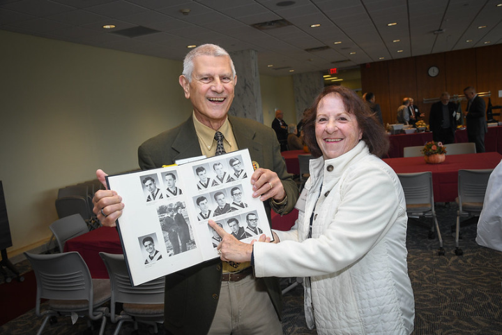 Alumni finding their yearbook photo at the 50+ reunion