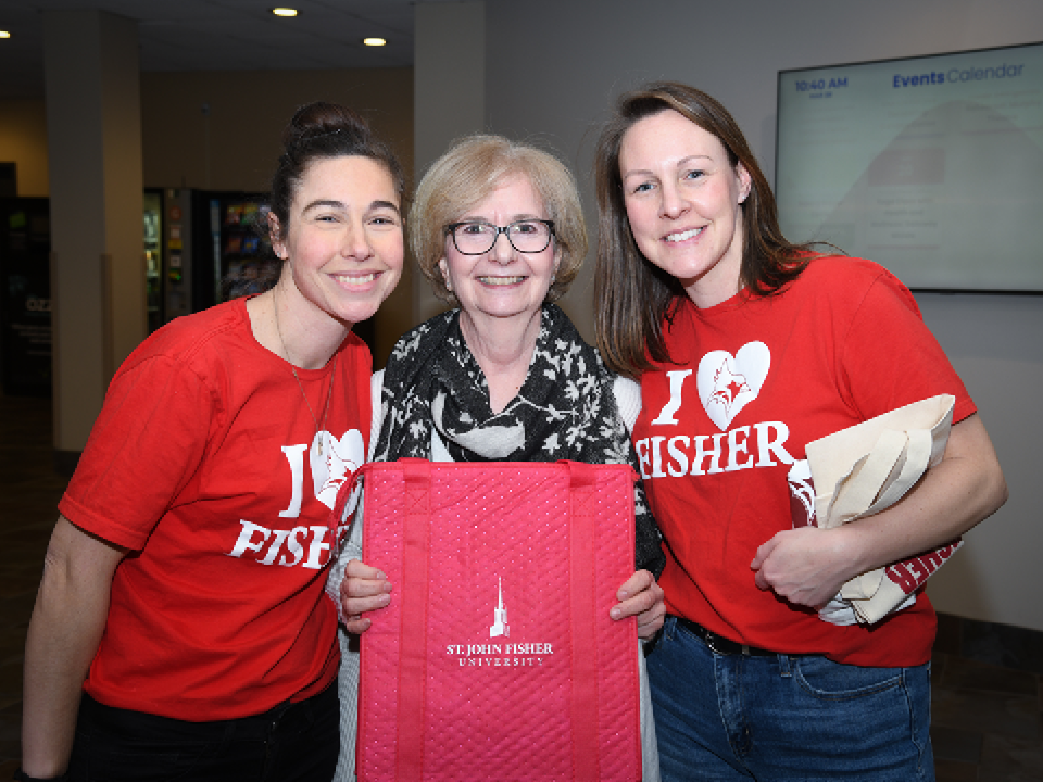 Three faculty members together celebrating Fisher