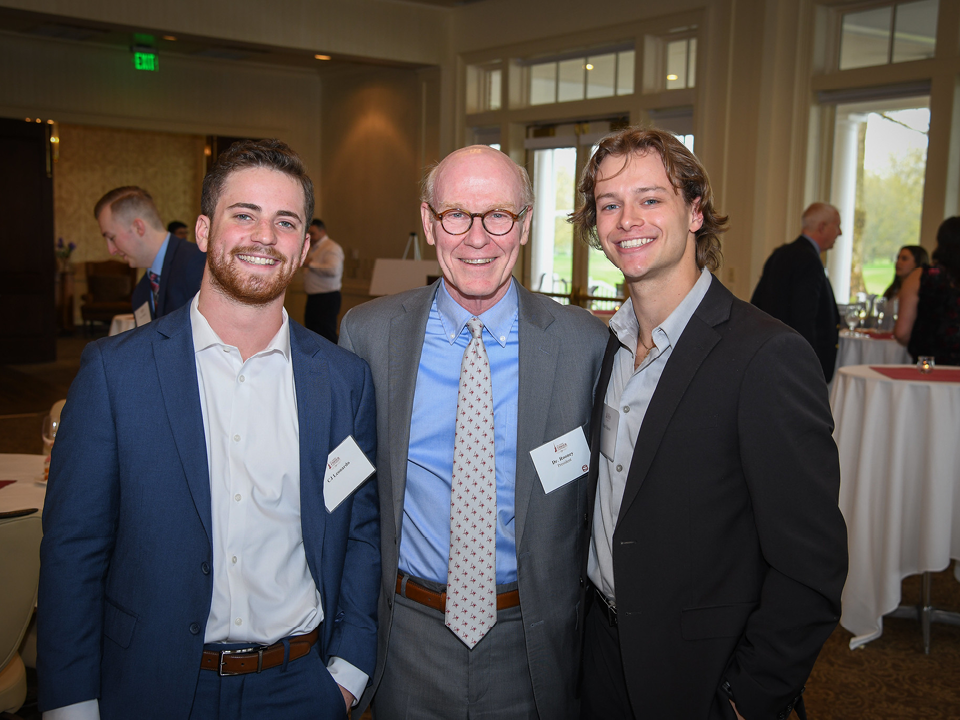 Two students with President Rooney