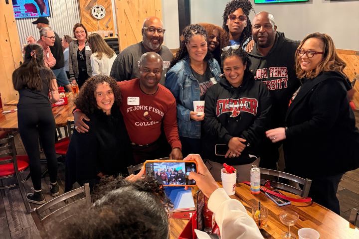 A group of 1996 alumni pose for a photo at a reunion event