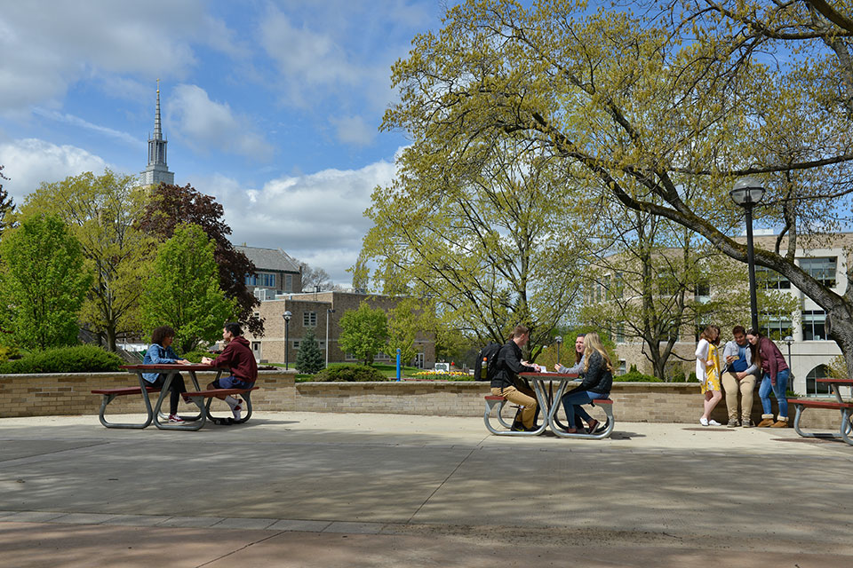 Students sit at the picnic tables in LeChase Commons.