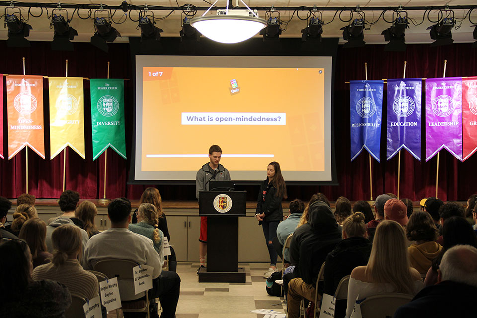 Two first-year students deliver a presentation about the Fisher Creed.