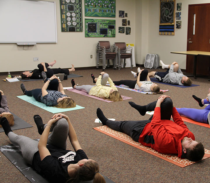 Students perform yoga during the course, Yoga and Mindfulness for Educators.
