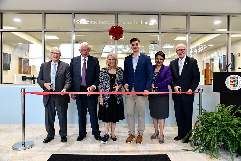 Vic Salerno, Walter and Barbara Parkes, Anthony Kousmanidis, Dean Rama Yelkur, and President Gerard Rooney cut the ribbon on the newly opened Parkes Trading Lab.