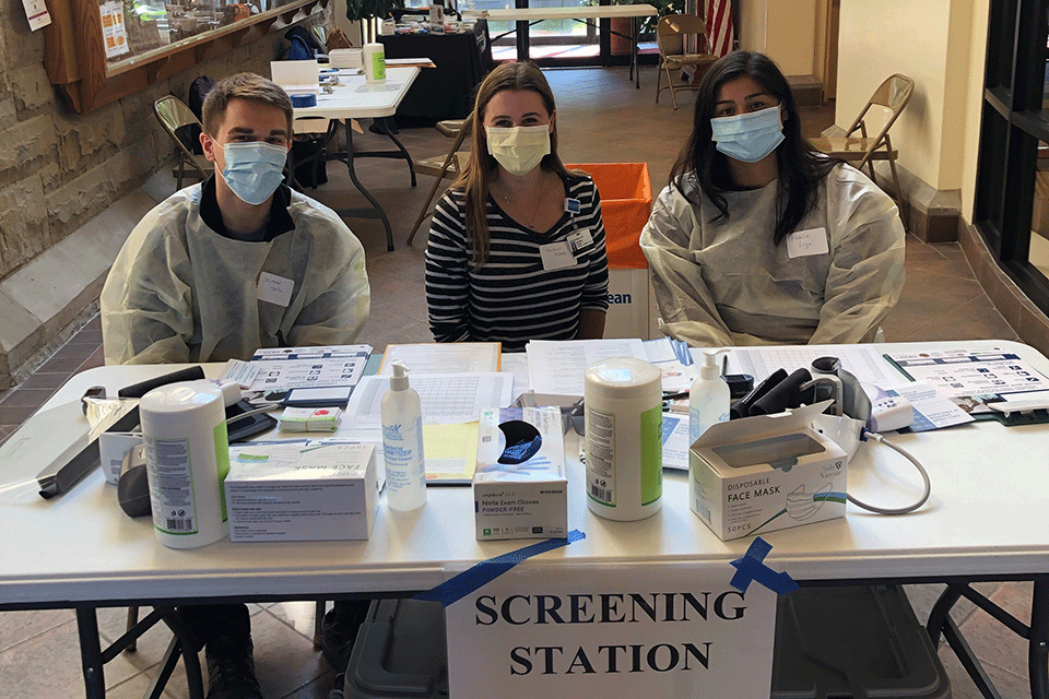 Desmond Martz, Mackenzie Roberts, and Natalie Lugo, all members of the Wegmans School of Pharmacy, volunteered at the mobile clinic.