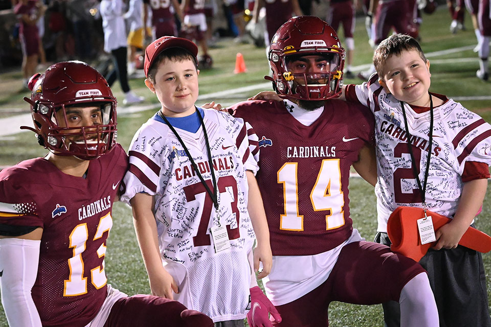 Fisher football players with the Courage Bowl Honorary Football Coaches.