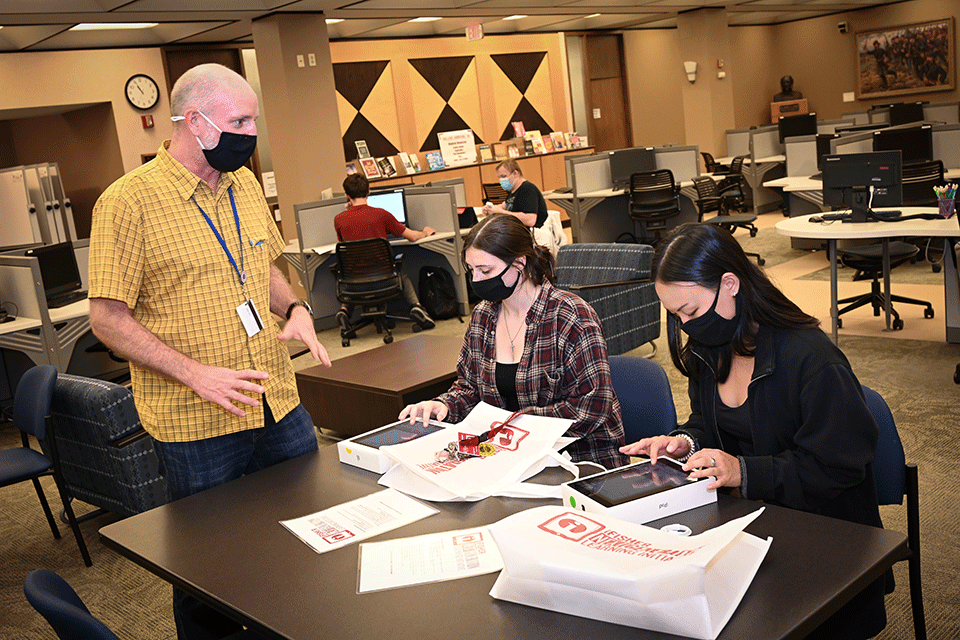 Dr. Mike Boller helps students set up their new iPads.