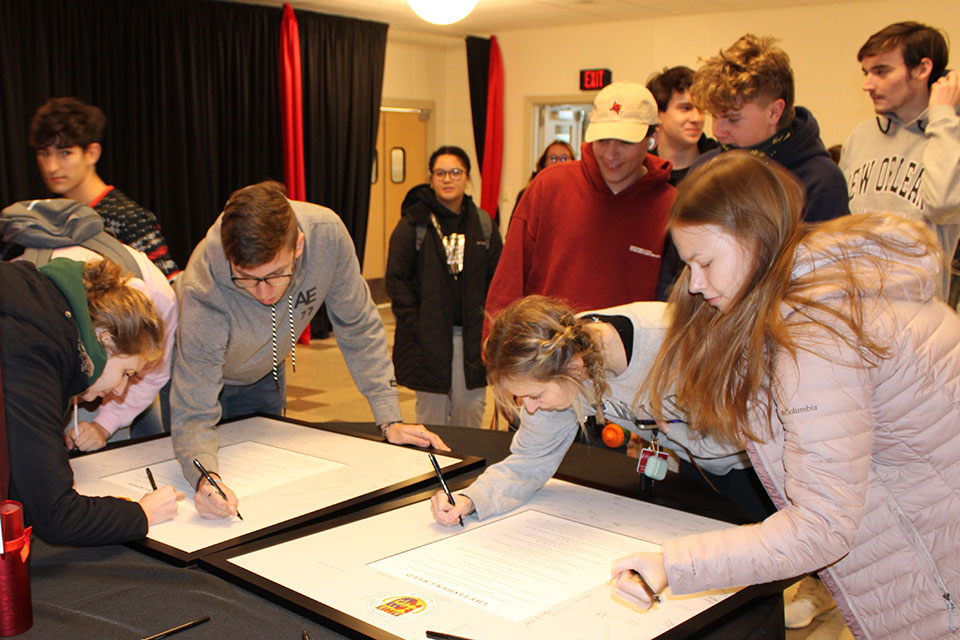 Students sign the Fisher Creed, which will be displayed in the Donald E. Bain Campus Center.