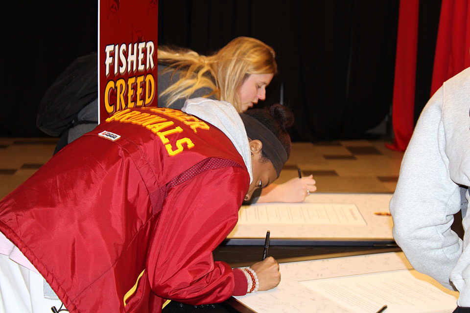 Students sign the Fisher Creed.