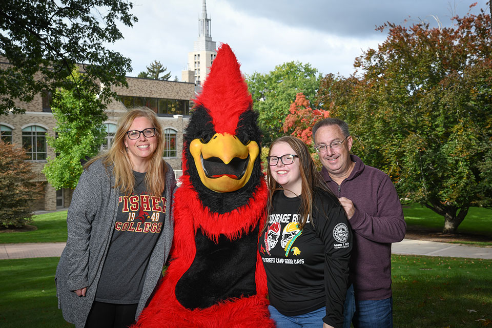 A fisher family takes a portrait photograph with Cardinal.