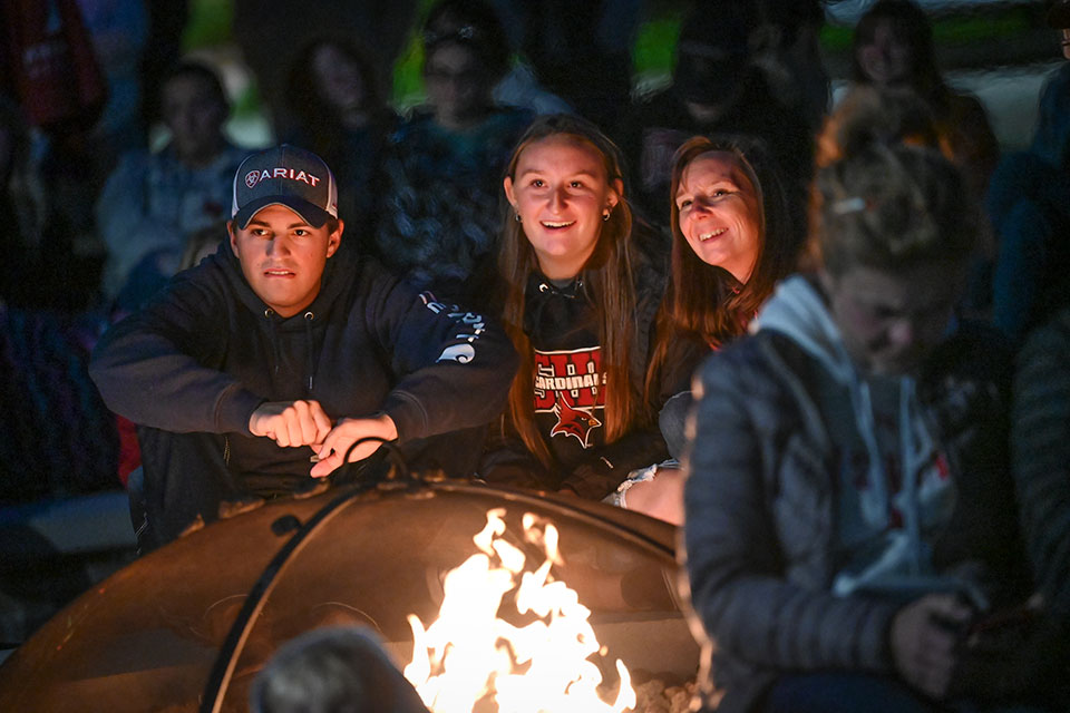 A Fisher family enjoys a fire and music on the Terrace at Tepas Commons.