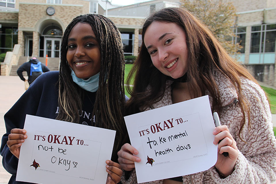 Students at the 2021 Fresh Check Day hold up signs of encouragement.