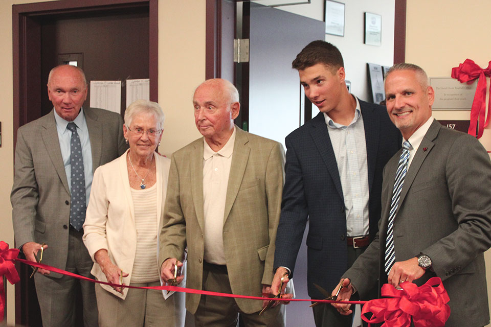 From left to right: Bob Ward, The Ocorrs, Noah Campanelli, and Jose Perales cut the ribbon on the newly renamed coaching office.