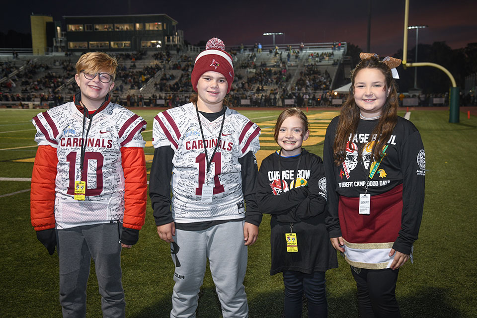 Courage Bowl Honorary Coaches Jack Harrison and Braxton Anjo with Honorary Cheerleaders Kya Bach and Karleigh Sackett.