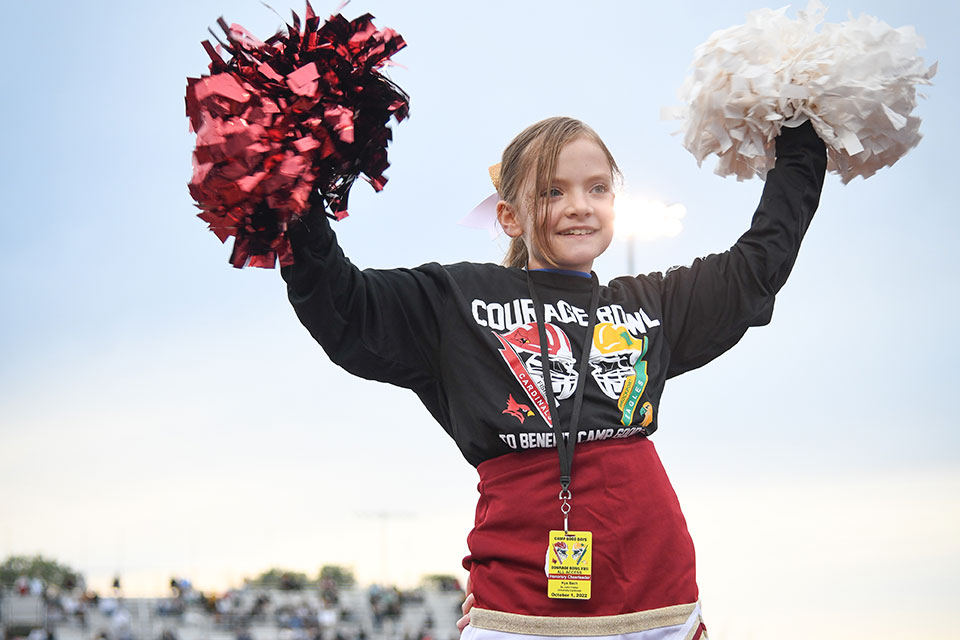 Honorary cheerleader Kya Bach cheers on the Cardinals.