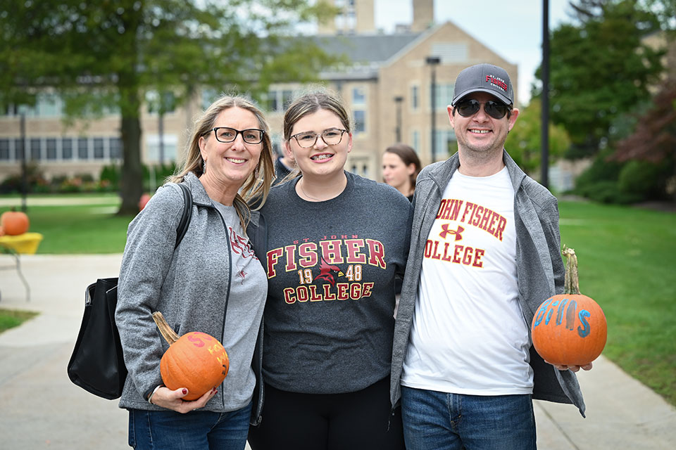A family enjoys fall activities during the 2021 Family Weekend.