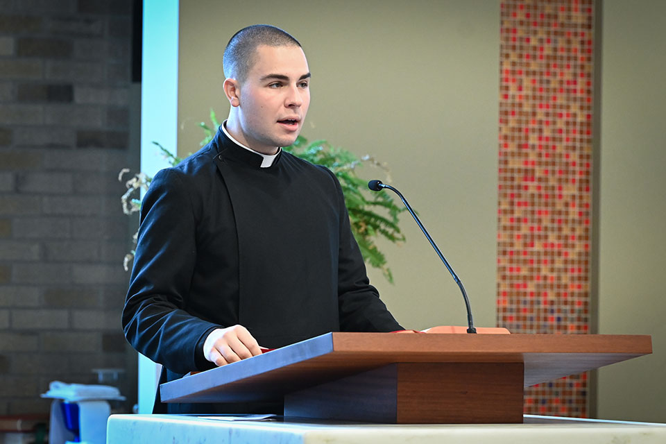 Graduate CJ Wild, a Seminarian, Ensign to the U.S. Navy who is studying for priesthood, delivers remarks during the Alumni Weekend Mass.