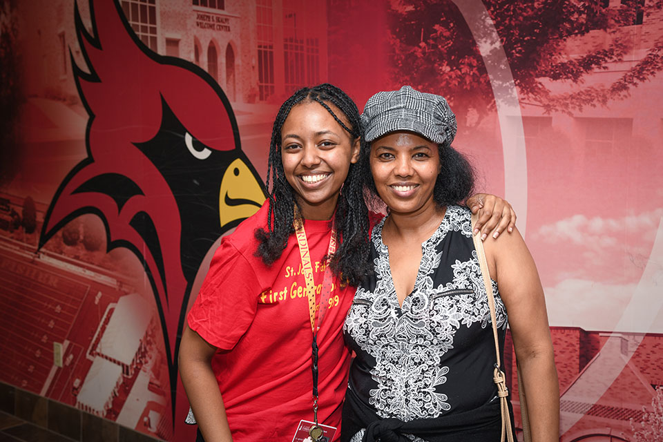 A Fisher family show off their Cardinal pride in front of Tepas Commons.