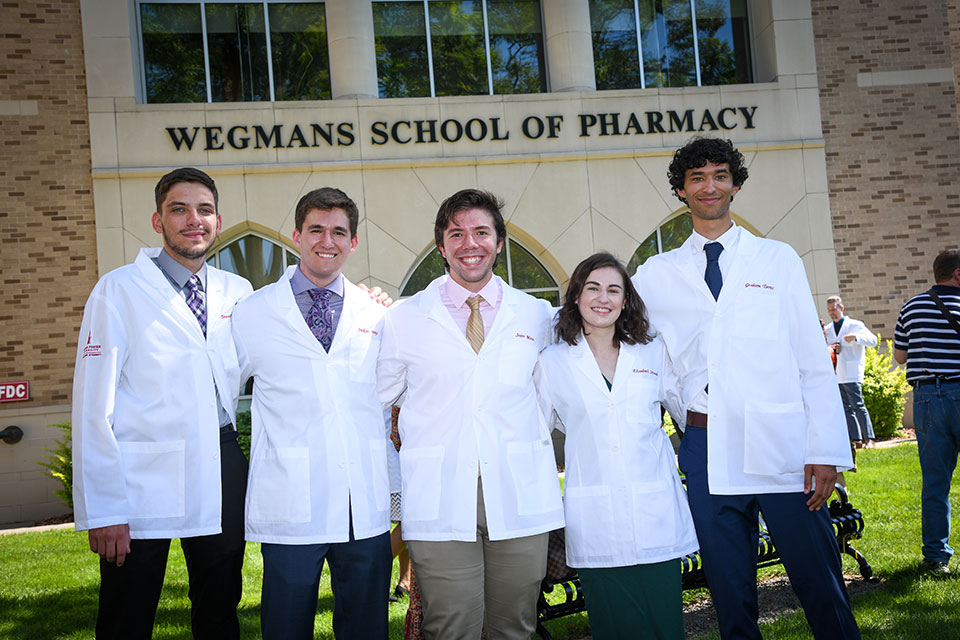 Students celebrate after receiving their white coats.