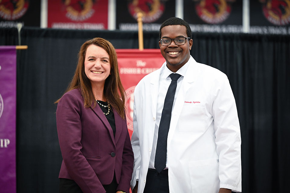 Dean Birnie poses with a first-year pharmacy student.