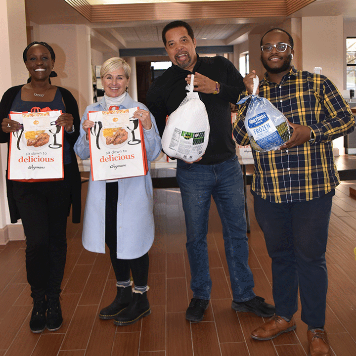 Members of the Wegmans School of Nursing and Mt. Olivet Baptist Church handed out Thanksgiving baskets to families in Rochester.