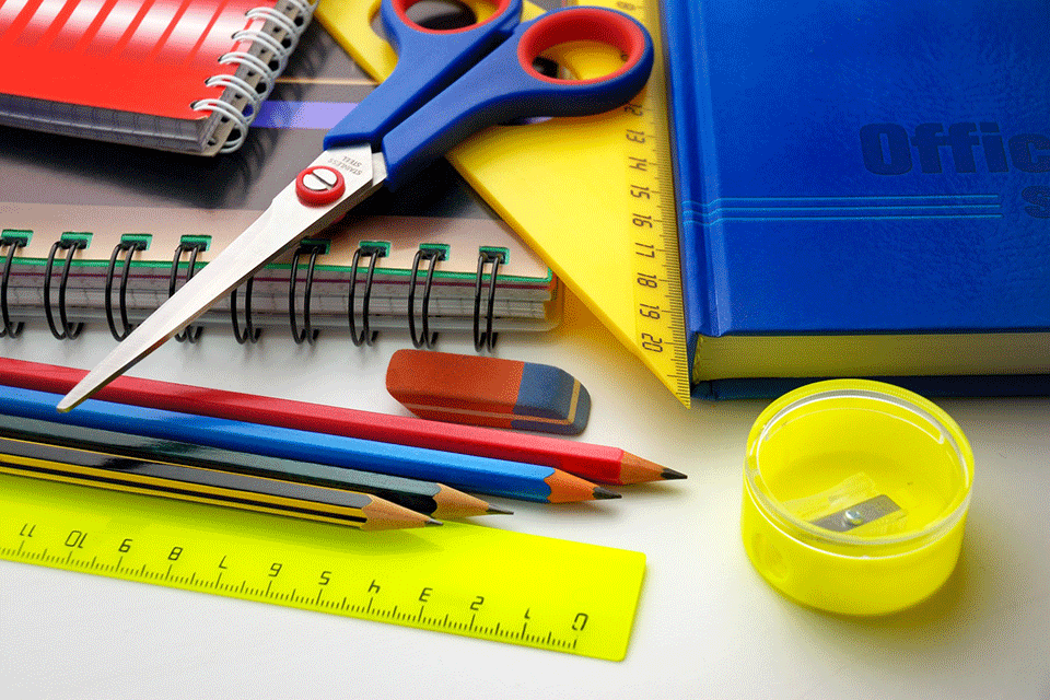 School supplies including pencils, notebooks, rules, and scissors.