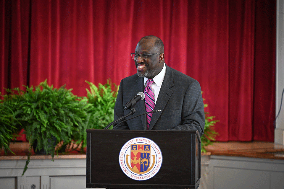 Marlowe Washington speaks at a podium.