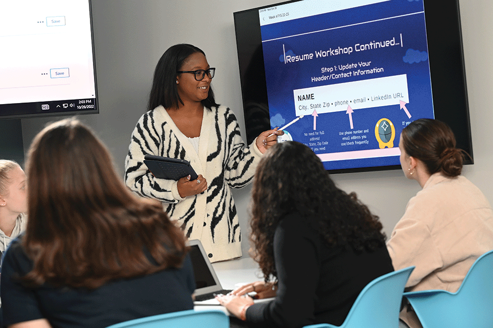 Students work on a presentation in a Basil Hall classroom.