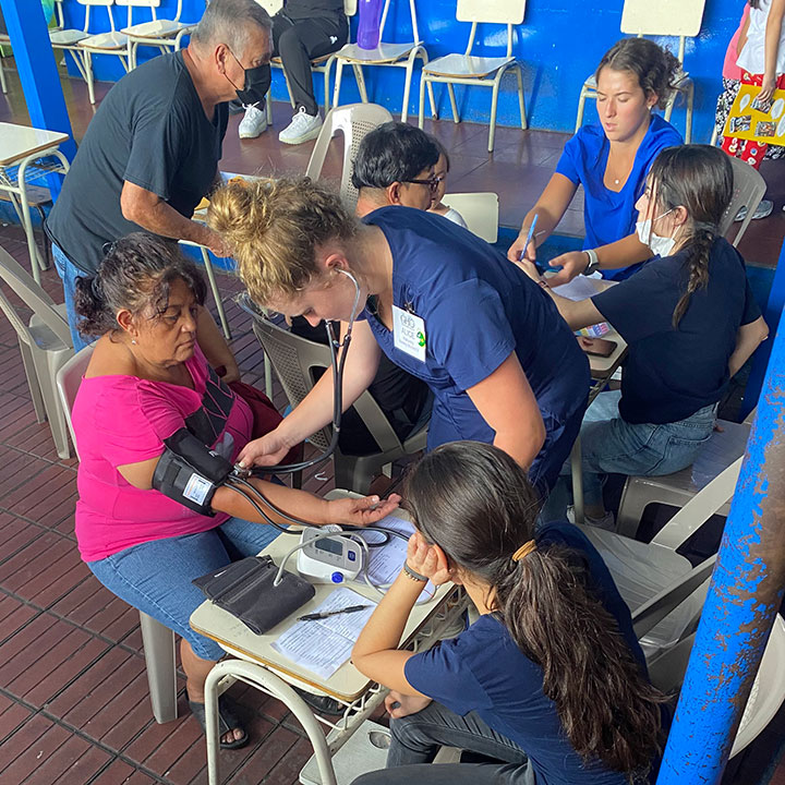 Nursing student Alice Mahoney takes a patient's blood pressure at a clinic in El Salvador.