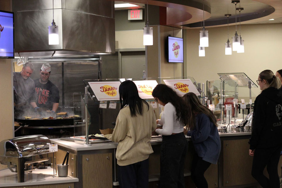 Students create smash burgers during Diner Night in Ward-Haffey Dining Hall.