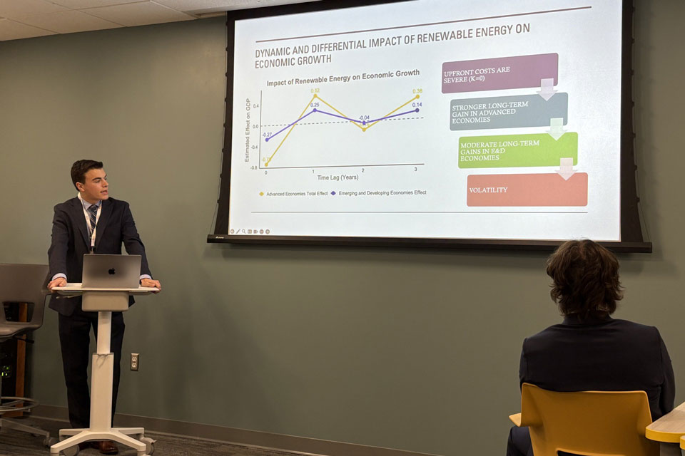 A student presents at the economics association conference.