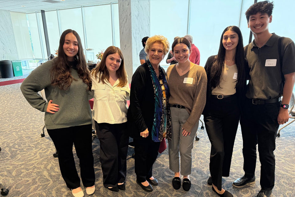 Lucy Malmberg poses with students from the Wegmans School of Pharmacy.
