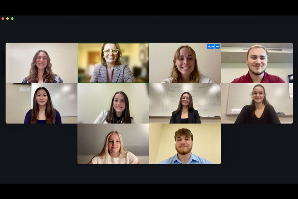 Dr. Monica Hodis with students and judges on Zoom.