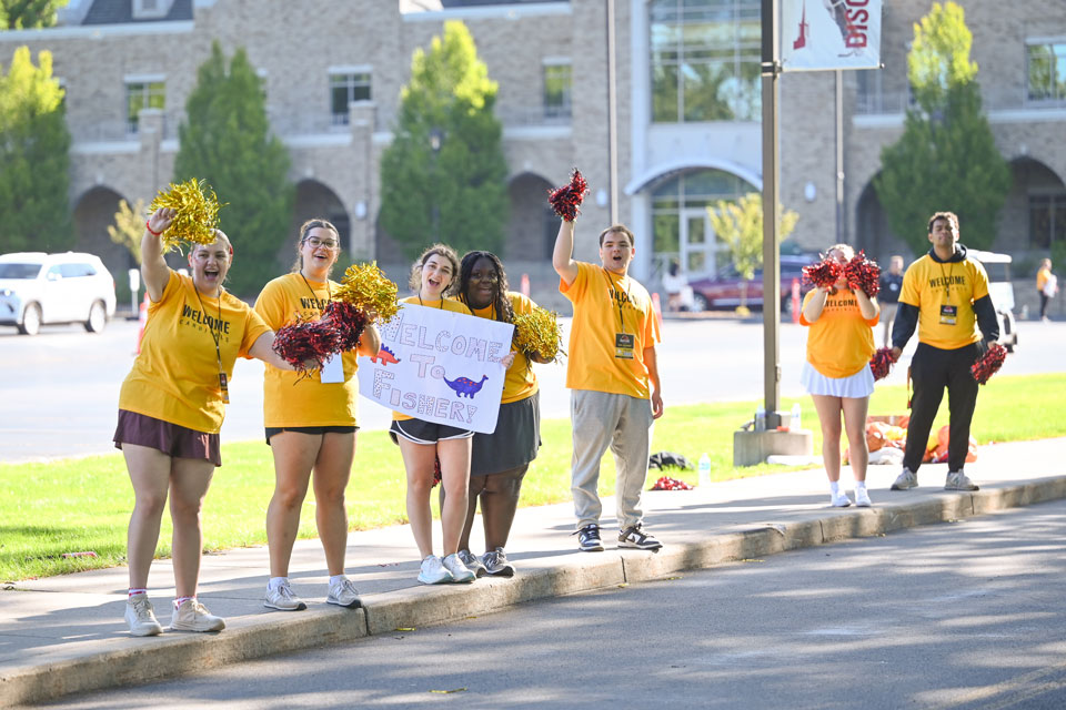 Students hold up welcome signs!