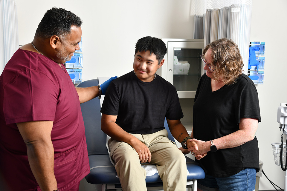 A nurse working with an IDD patient and their caregiver.