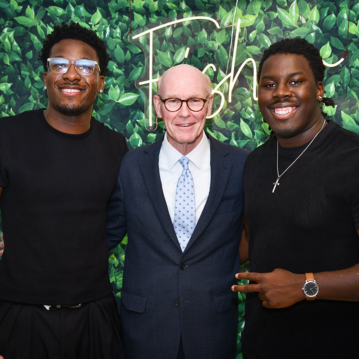 Students Isaac Turenne (L) and Brandon Davis (R) with President Rooney