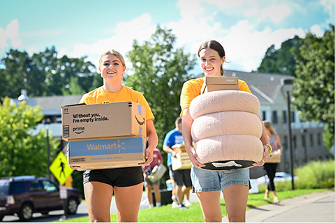 Orientation students moving new students into residence halls.