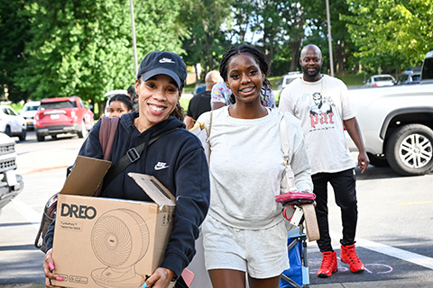 A student and her family moving into her residence hall.