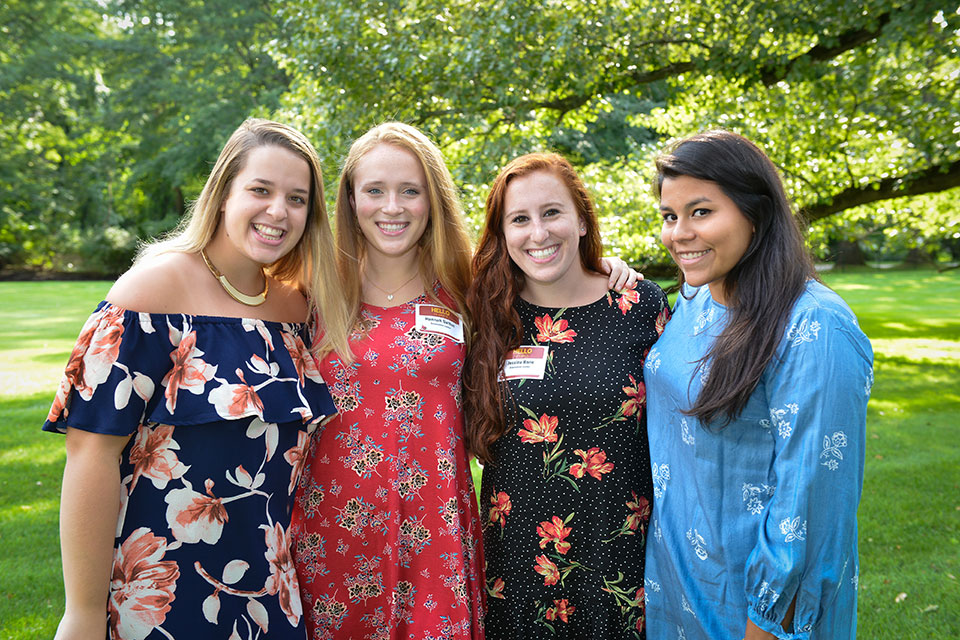Madison Seamon with friends at an orientation leaders dinner at the President's Residence.