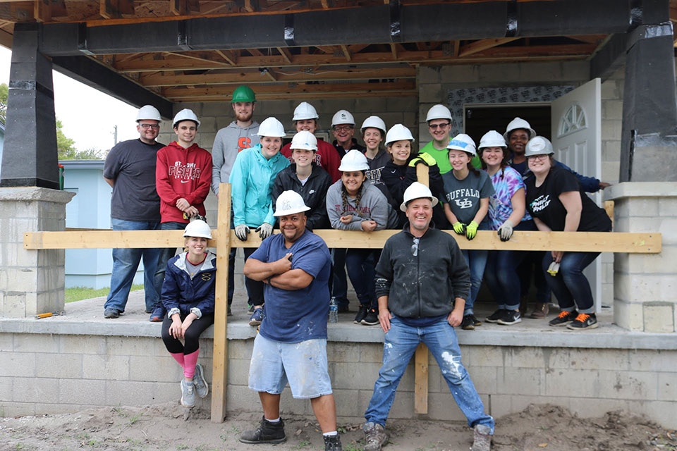 In Tampa, Fisher students worked on a Habitat house, installing insulation and finishing the roof.